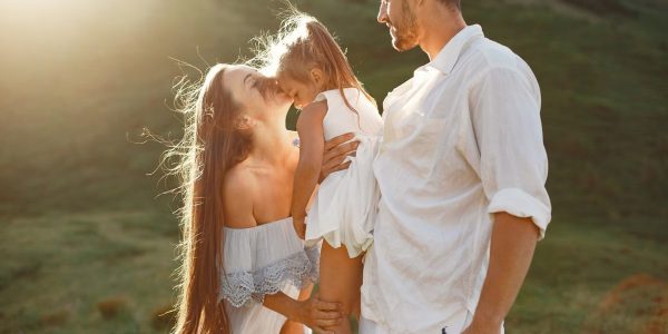 A joyful family embracing during a sunset outdoors, showcasing love and togetherness.